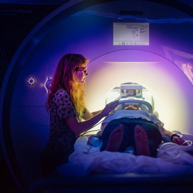 Graduate student performing an fMRI scan.
